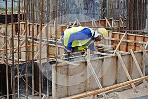 Group of construction workers fabricating ground beam formwork